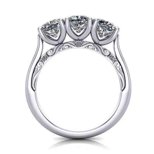Kora cushion three-stone engagement ring in 18K White Gold, through-finger front profile showing the open scrollwork under-gallery and pave-set accents