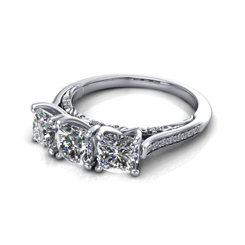 Emory cushion three-stone engagement ring in 18K White Gold, three-quarter perspective showing the three matched cushion diamonds, pave-set band, and filigree under-gallery
