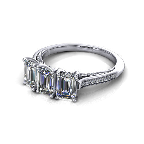 Emory emerald-cut three-stone engagement ring in 14K White Gold, three-quarter perspective showing the three matched emerald-cut diamonds, pave-set band, and filigree under-gallery