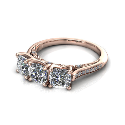 Emory cushion three-stone engagement ring in 14K Rose Gold, three-quarter perspective showing the three matched cushion diamonds, pave-set band, and filigree under-gallery