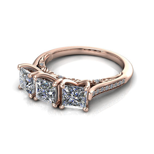 Emory princess-cut three-stone engagement ring in 14K Rose Gold, three-quarter perspective showing the three matched princess-cut diamonds, pave-set band, and filigree under-gallery