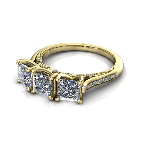 Emory princess-cut three-stone engagement ring in 18K Yellow Gold, three-quarter perspective showing the three matched princess-cut diamonds, pave-set band, and filigree under-gallery