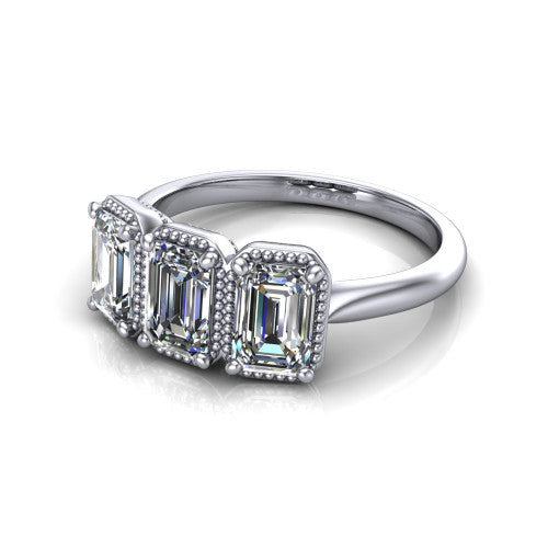 Evangeline emerald-cut three-stone engagement ring in 14K White Gold, three-quarter perspective showing three emerald-cut diamonds in milgrain bezels on a polished tapered band