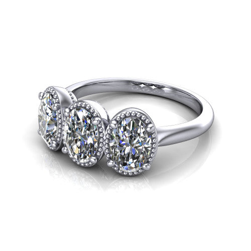 Evangeline oval three-stone engagement ring in Platinum, three-quarter perspective showing three oval diamonds in milgrain bezels on a polished tapered band
