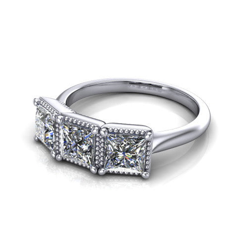 Evangeline princess-cut three-stone engagement ring in 18K White Gold, three-quarter perspective showing three princess-cut diamonds in milgrain bezels on a polished tapered band