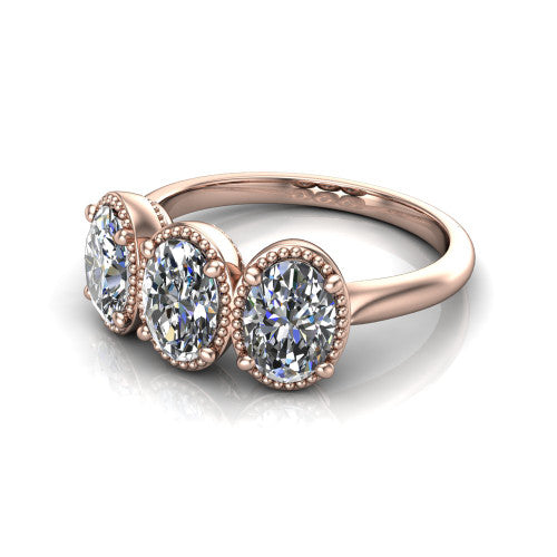 Evangeline oval three-stone engagement ring in 14K Rose Gold, three-quarter perspective showing three oval diamonds in milgrain bezels on a polished tapered band