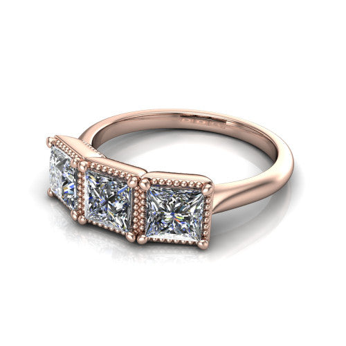 Evangeline princess-cut three-stone engagement ring in 18K Rose Gold, three-quarter perspective showing three princess-cut diamonds in milgrain bezels on a polished tapered band