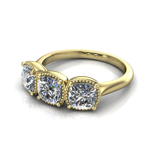 Evangeline cushion three-stone engagement ring in 18K Yellow Gold, three-quarter perspective showing three cushion diamonds in milgrain bezels on a polished tapered band