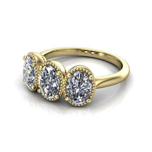 Evangeline oval three-stone engagement ring in 18K Yellow Gold, three-quarter perspective showing three oval diamonds in milgrain bezels on a polished tapered band