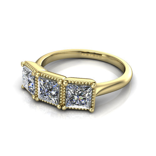 Evangeline princess-cut three-stone engagement ring in 14K Yellow Gold, three-quarter perspective showing three princess-cut diamonds in milgrain bezels on a polished tapered band