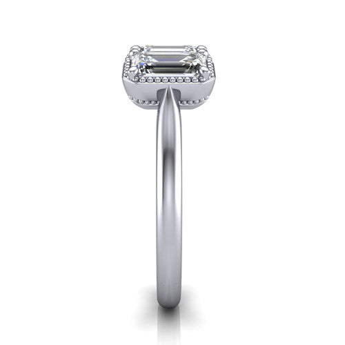 Evangeline emerald-cut three-stone engagement ring in Platinum, side profile showing the milgrain bezels and clean polished band in profile