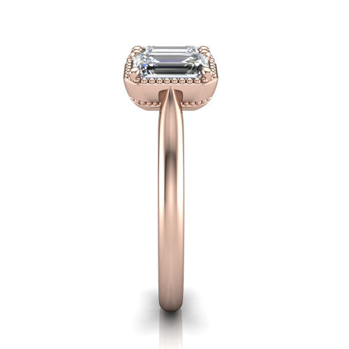 Evangeline emerald-cut three-stone engagement ring in 14K Rose Gold, side profile showing the milgrain bezels and clean polished band in profile