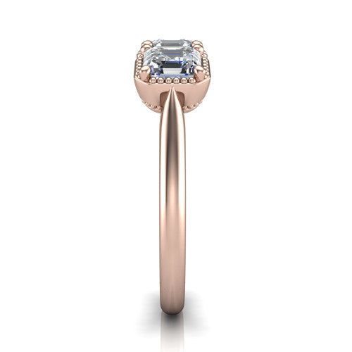 Evangeline square emerald-cut three-stone engagement ring in 18K Rose Gold, side profile showing the milgrain bezels and clean polished band in profile
