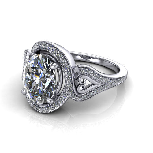 Elisa oval vintage halo engagement ring in Platinum, three-quarter perspective showing the oval center diamond, pave halo, and vintage filigree heart-scroll shoulders