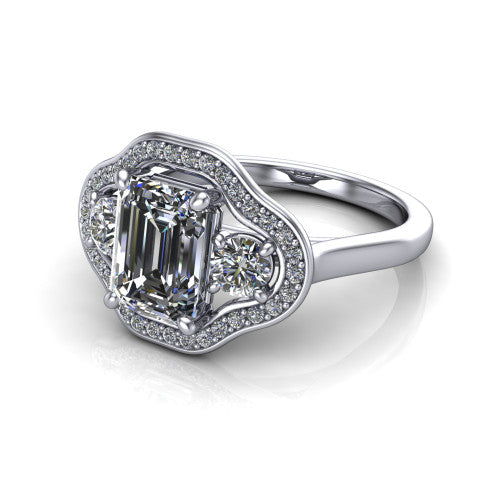 Makayla emerald-cut three-stone halo engagement ring in 18K White Gold, three-quarter perspective showing the emerald-cut center diamond, two side stones, and individual pave halos on the east-west gallery