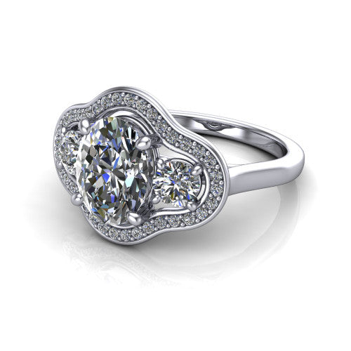 Makayla oval three-stone halo engagement ring in Platinum, three-quarter perspective showing the oval center diamond, two side stones, and individual pave halos on the east-west gallery