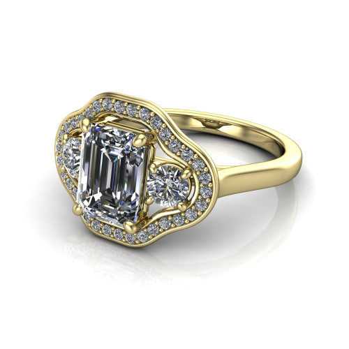 Makayla emerald-cut three-stone halo engagement ring in 18K Yellow Gold, three-quarter perspective showing the emerald-cut center diamond, two side stones, and individual pave halos on the east-west gallery