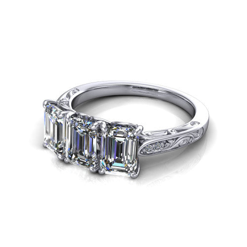 Navy emerald three stone engagement ring in 18K White Gold, three-quarter perspective showing three emerald diamonds above an engraved filigree band