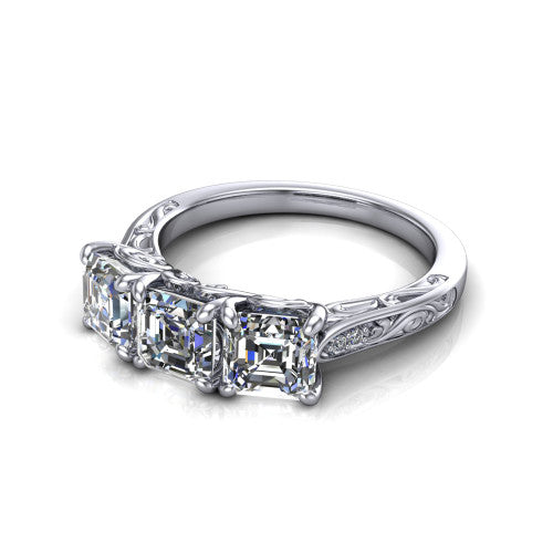 Navy square emerald three stone engagement ring in 18K White Gold, three-quarter perspective showing three square emerald diamonds above an engraved filigree band