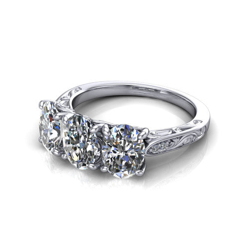 Navy oval three stone engagement ring in 14K White Gold, three-quarter perspective showing three oval diamonds above an engraved filigree band
