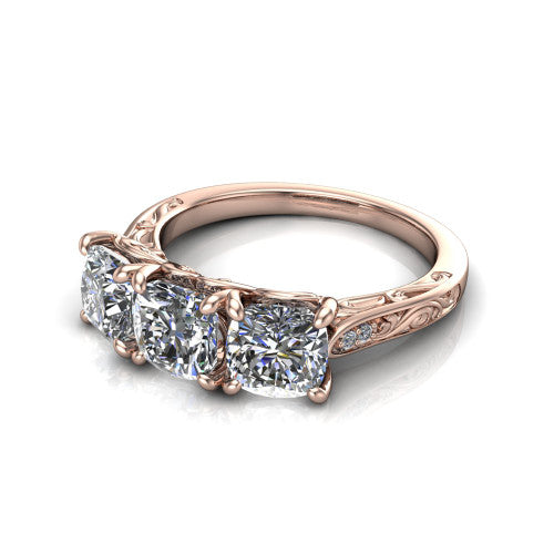 Navy cushion three stone engagement ring in 18K Rose Gold, three-quarter perspective showing three cushion diamonds above an engraved filigree band
