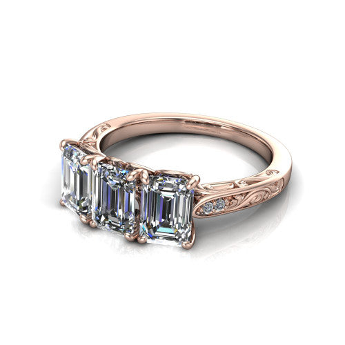 Navy emerald three stone engagement ring in 18K Rose Gold, three-quarter perspective showing three emerald diamonds above an engraved filigree band