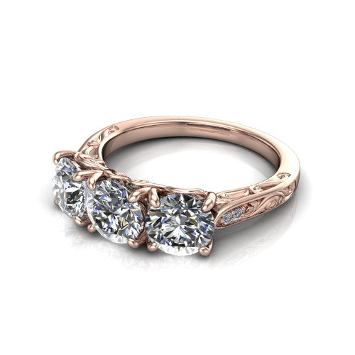 Navy round three stone engagement ring in 18K Rose Gold, three-quarter perspective showing three round diamonds above an engraved filigree band