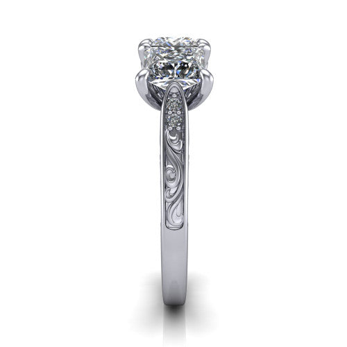 Navy princess three stone engagement ring in Platinum, side profile showing the vintage engraved filigree band and the raised three-stone setting