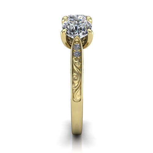 Navy cushion three stone engagement ring in 18K Yellow Gold, side profile showing the vintage engraved filigree band and the raised three-stone setting