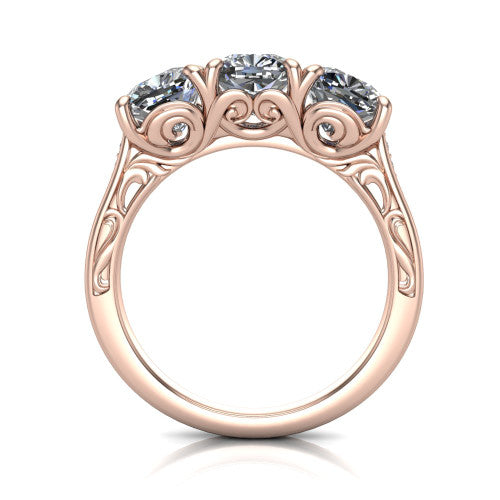 Navy cushion three stone engagement ring in 14K Rose Gold, through-finger front profile showing the filigree scroll gallery beneath the three stones