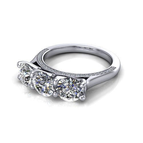 Maryam round three stone engagement ring in Platinum, three-quarter perspective showing three round diamonds set side by side above a pav&eacute; band