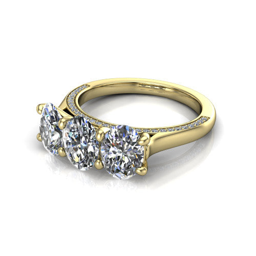 Maryam oval three stone engagement ring in 18K Yellow Gold, three-quarter perspective showing three oval diamonds set side by side above a pav&eacute; band