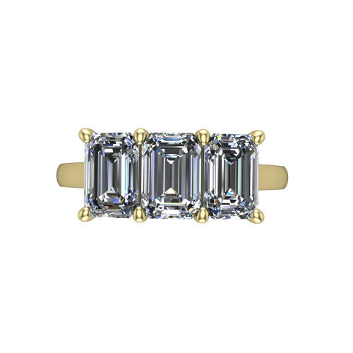 Maryam emerald three stone engagement ring in 18K Yellow Gold, top-down view showing the trio of emerald stones set in a row