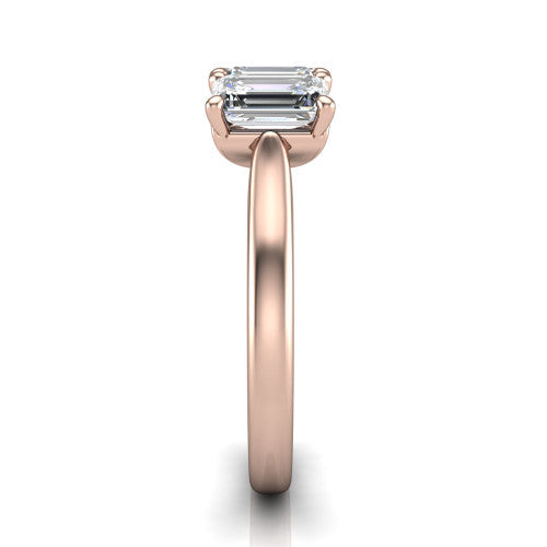 Amora emerald three stone engagement ring in 14K Rose Gold, side profile showing the plain polished band and the raised three-stone setting