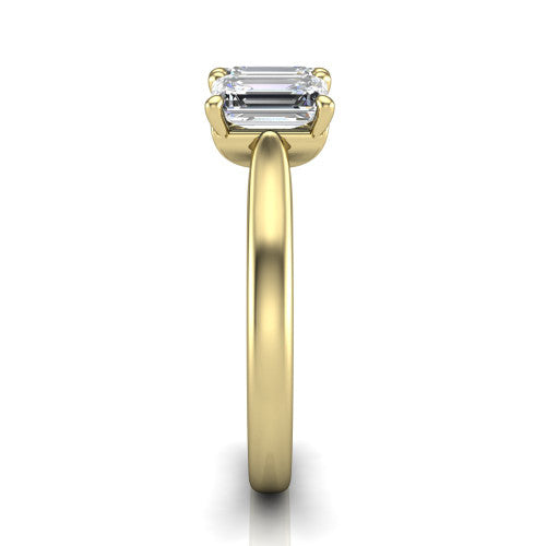 Amora emerald three stone engagement ring in 14K Yellow Gold, side profile showing the plain polished band and the raised three-stone setting