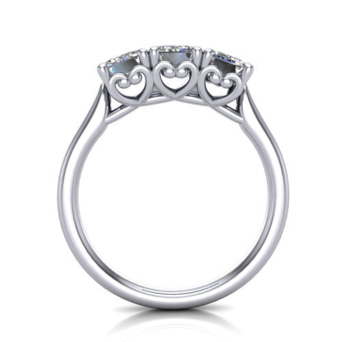Amora emerald three stone engagement ring in Platinum, through-finger side profile showing the heart filigree scroll gallery beneath the three stones