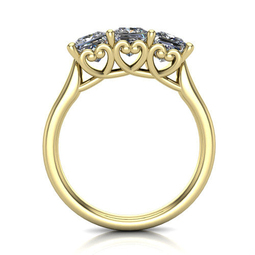 Amora princess three stone engagement ring in 18K Yellow Gold, through-finger side profile showing the heart filigree scroll gallery beneath the three stones