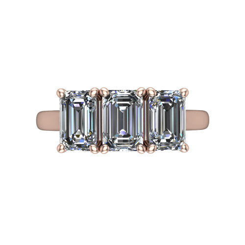 Amora emerald three stone engagement ring in 14K Rose Gold, top-down view showing the trio of emerald stones set in a row
