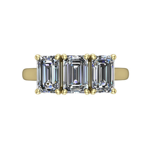 Amora emerald three stone engagement ring in 18K Yellow Gold, top-down view showing the trio of emerald stones set in a row