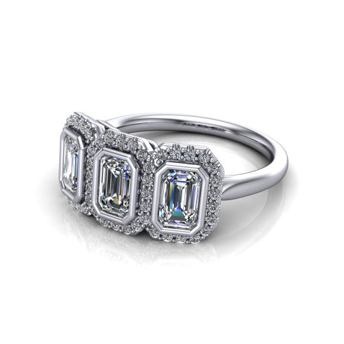 Lorelei emerald three stone halo engagement ring in 14K White Gold, three-quarter perspective showing three emerald stones each in a squared pav&eacute; halo above a plain band