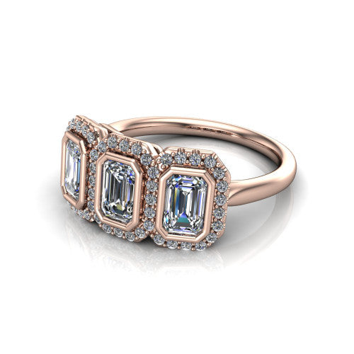 Lorelei emerald three stone halo engagement ring in 14K Rose Gold, three-quarter perspective showing three emerald stones each in a squared pav&eacute; halo above a plain band
