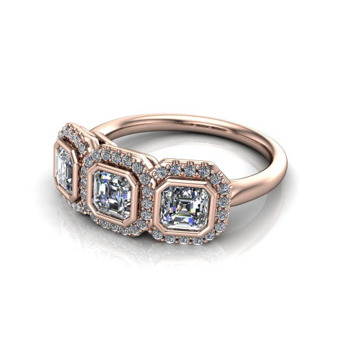 Lorelei square emerald three stone halo engagement ring in 14K Rose Gold, three-quarter perspective showing three square emerald stones each in a squared pav&eacute; halo above a plain band