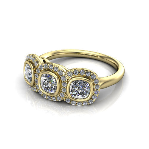Lorelei cushion three stone halo engagement ring in 18K Yellow Gold, three-quarter perspective showing three cushion stones each in a squared pav&eacute; halo above a plain band