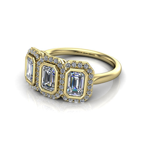 Lorelei emerald three stone halo engagement ring in 14K Yellow Gold, three-quarter perspective showing three emerald stones each in a squared pav&eacute; halo above a plain band