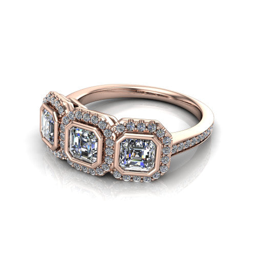 Aviana square emerald three stone halo engagement ring in 18K Rose Gold, three-quarter perspective showing three square emerald stones each in a squared pav&eacute; halo above a pav&eacute; band