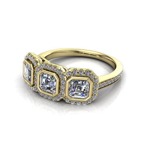 Aviana square emerald three stone halo engagement ring in 18K Yellow Gold, three-quarter perspective showing three square emerald stones each in a squared pav&eacute; halo above a pav&eacute; band