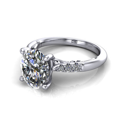 Jimena oval solitaire engagement ring in Platinum, three-quarter perspective showing the oval center raised on claw prongs above pav&eacute; shoulders