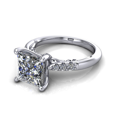 Jimena princess solitaire engagement ring in Platinum, three-quarter perspective showing the princess center raised on claw prongs above pav&eacute; shoulders