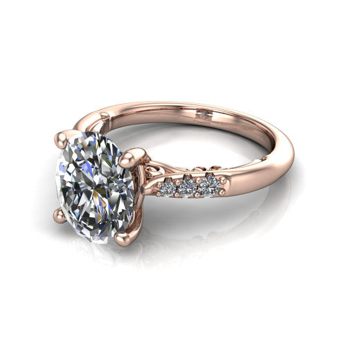 Jimena oval solitaire engagement ring in 18K Rose Gold, three-quarter perspective showing the oval center raised on claw prongs above pav&eacute; shoulders