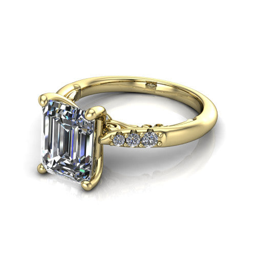 Jimena emerald solitaire engagement ring in 14K Yellow Gold, three-quarter perspective showing the emerald center raised on claw prongs above pav&eacute; shoulders
